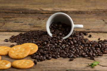 Cup of coffee on a wooden board and biscuits