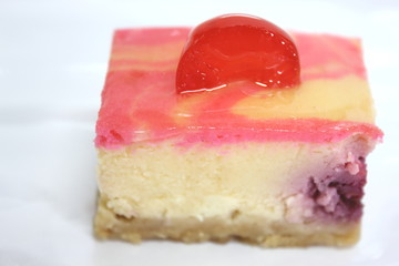 piece of cherry cake on white isolated background.