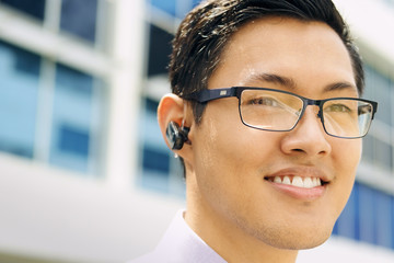 Headshot Business Man With Bluetooth Handsfree Device