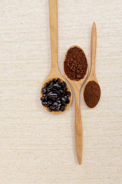 Coffee beans and coffee powder in wooden spoon 