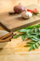 Cinnamon sticks on a sauce bowl on side
