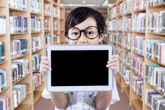 Little Girl With Tablet In Library Alley