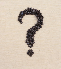 Coffee beans question mark shape on canvas background