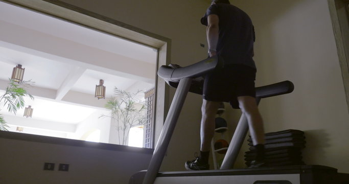 Man in the gym exercising on treadmill