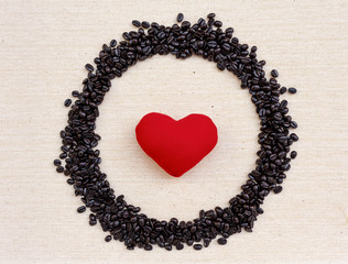 Red heart in coffee bean frame on canvas texture background