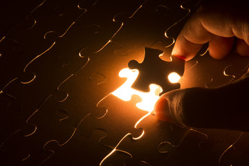 Missing jigsaw puzzle piece with light glow, business concept for completing the final puzzle piece - obrazy, fototapety, plakaty