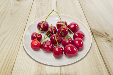Saucer with dark red cherries