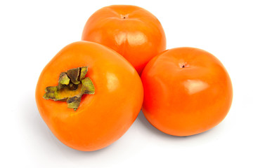 Three persimmons on white