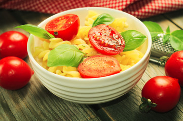 Traditional italian pasta with tmatoes and fresh basil. Selective focus