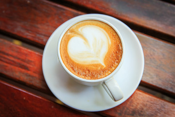coffee latte art on the wood desk at coffee shop