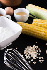 Flour and corn,egg,ingredients of bakery on black table