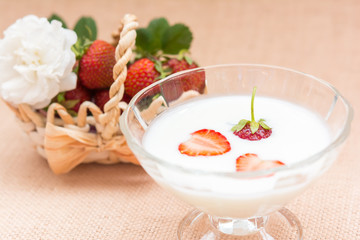 Yogurt with strawberry in glass bowl