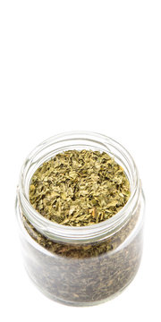 Dried parsley herb in a mason jar over white background