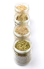 Obraz na płótnie Canvas Herbs variety of rosemary, parsley, bay leaves and thyme in mason jars 