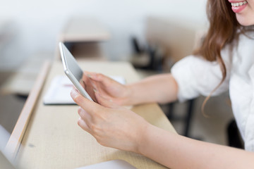 Asian beautiful female student study with tablet in classroom