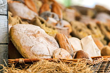 Mixed bread in a wicker basket, breakfast concept