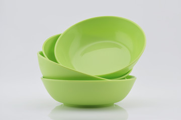 Green plastic bowls isolated on white