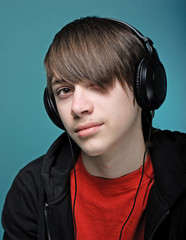 Teenager in headphones listening music