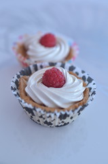 Cupcakes with cream and raspberry