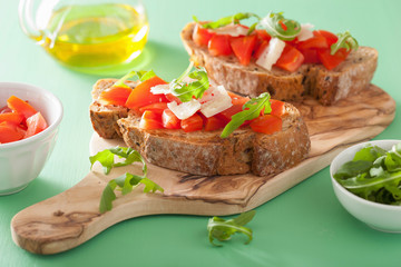 italian bruschetta with tomatoes parmesan arugula