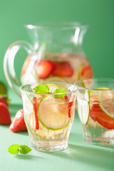 refreshing summer drink with strawberry cucumber lime in jar and