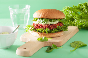 vegan beet and quinoa burger with avocado dressing