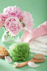 Fototapeta na wymiar bath and spa with peony flowers brush sponge towels