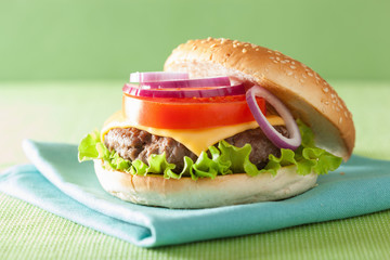 burger with beef patty cheese lettuce onion tomato