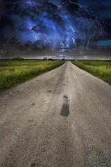 Lightning storm over asphalt road