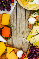 Cheese - different types of cheese on a wooden background