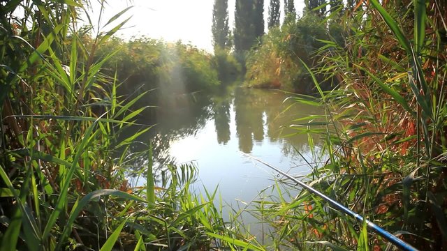 Fishing  in sunrise. Sunlight shines in the water. Spinning on