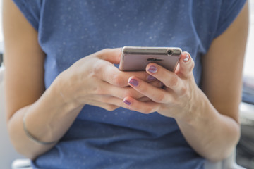 Woman typing message on mobile phone
