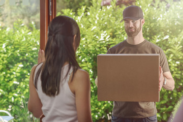 Woman answering the door to a deliveryman