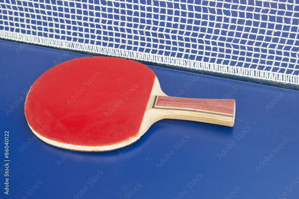 Wall mural table tennis racket and net on a blue table tennis table