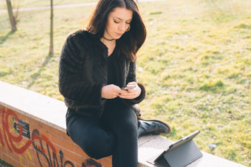 young beautiful woman using tablet and smartphone