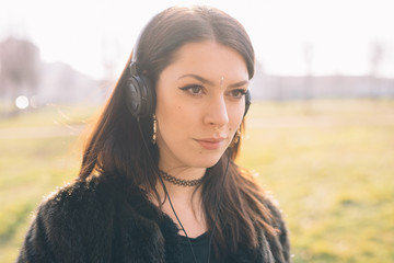 young beautiful woman listening to music with headphones