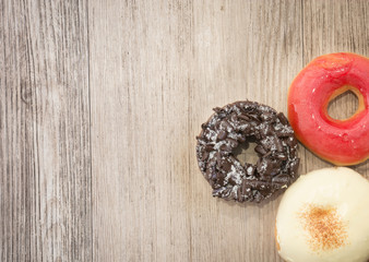 Donuts on wooden background