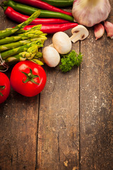 Colorful vegetables over old wooden table