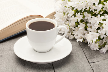Obraz na płótnie Canvas Cup of coffee while reading a book