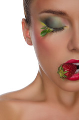 charming woman with strawberry in mouth