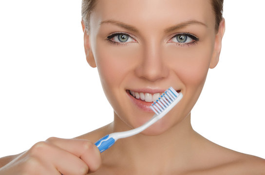 young woman with toothbrush in mouth
