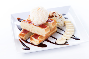 Belgian waffles with ice cream and whipped cream, Strawberry sauce and bananas