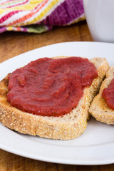 Fototapeta na wymiar Strawberry and rhubarb jam on toast bread for breakfast on table