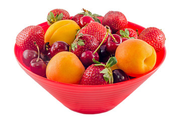 Red bowl with fruits, strawberry, apricots