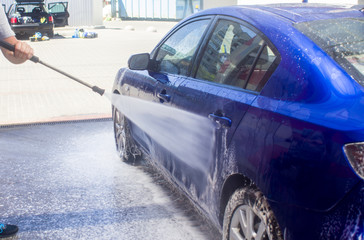 Car wash with flowing water and foam.