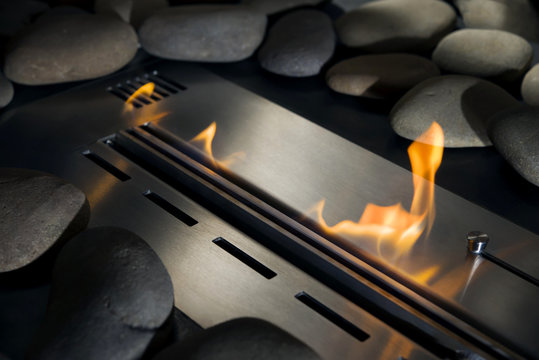 Modern bio fireplace made of stainless steel with a burning fire