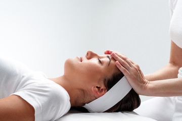 Woman relaxing at reiki session.