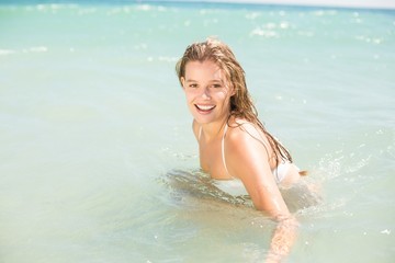 Happy pretty blonde bathing into the sea 