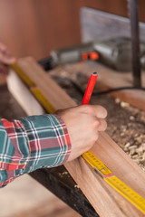 Man measuring a piece of wood