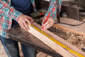Man measuring a piece of wood